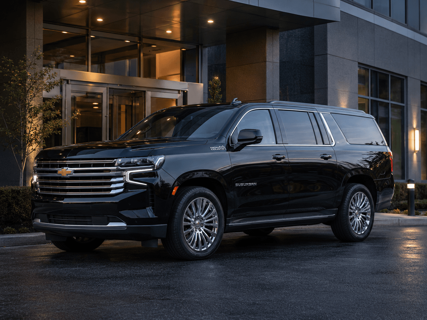 Black Chevrolet Suburban High Country outside a corporate building
