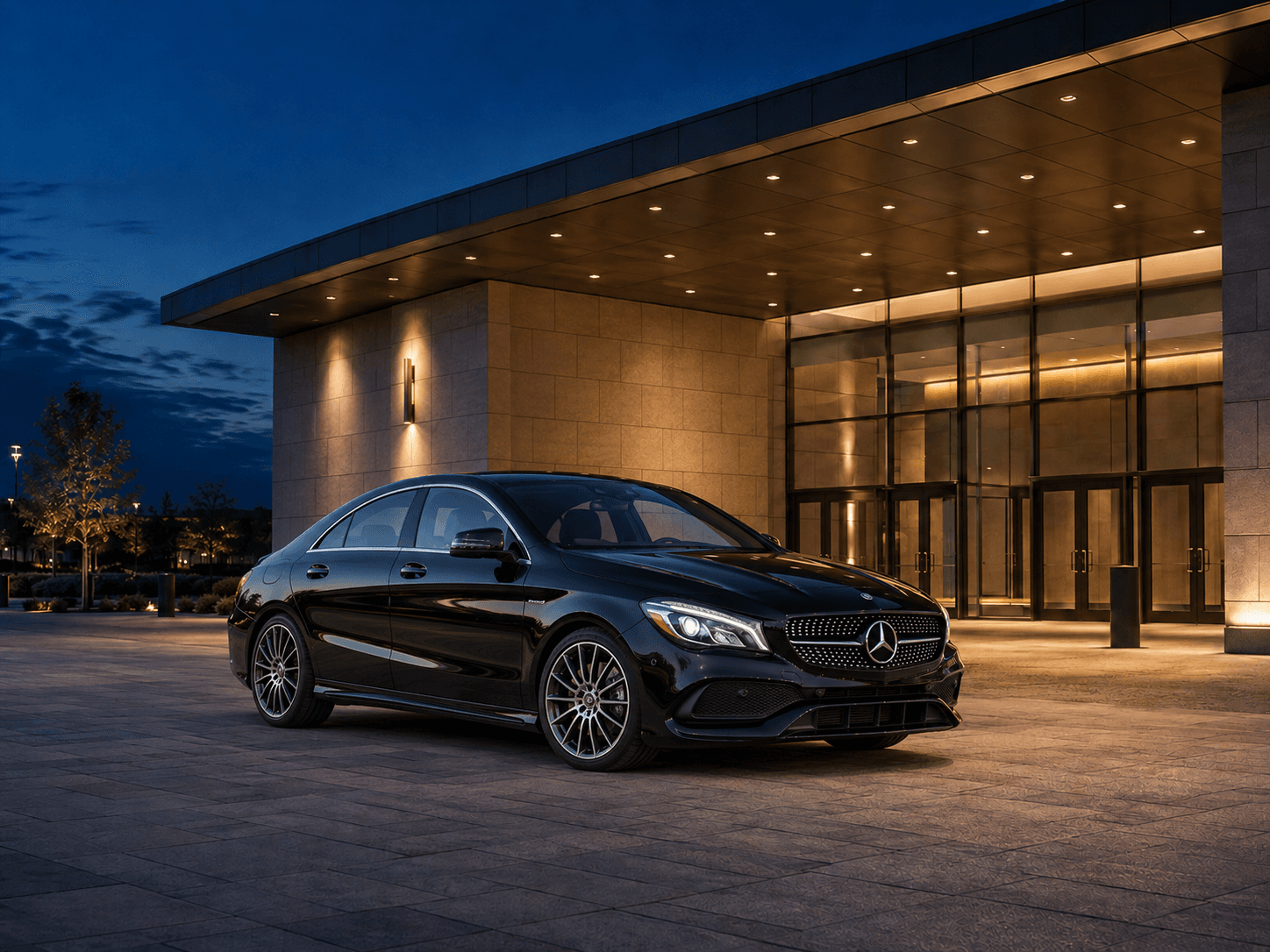 Black Mercedes-Benz CLA-Class AMG Line outside a modern conference center